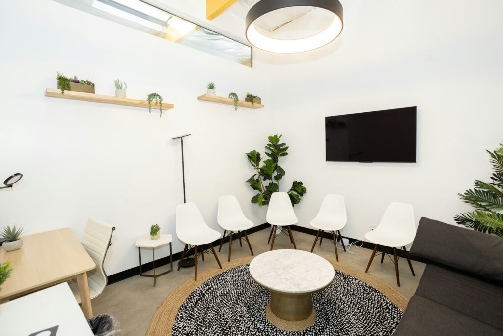 A light-filled waiting area with chairs and indoor plants